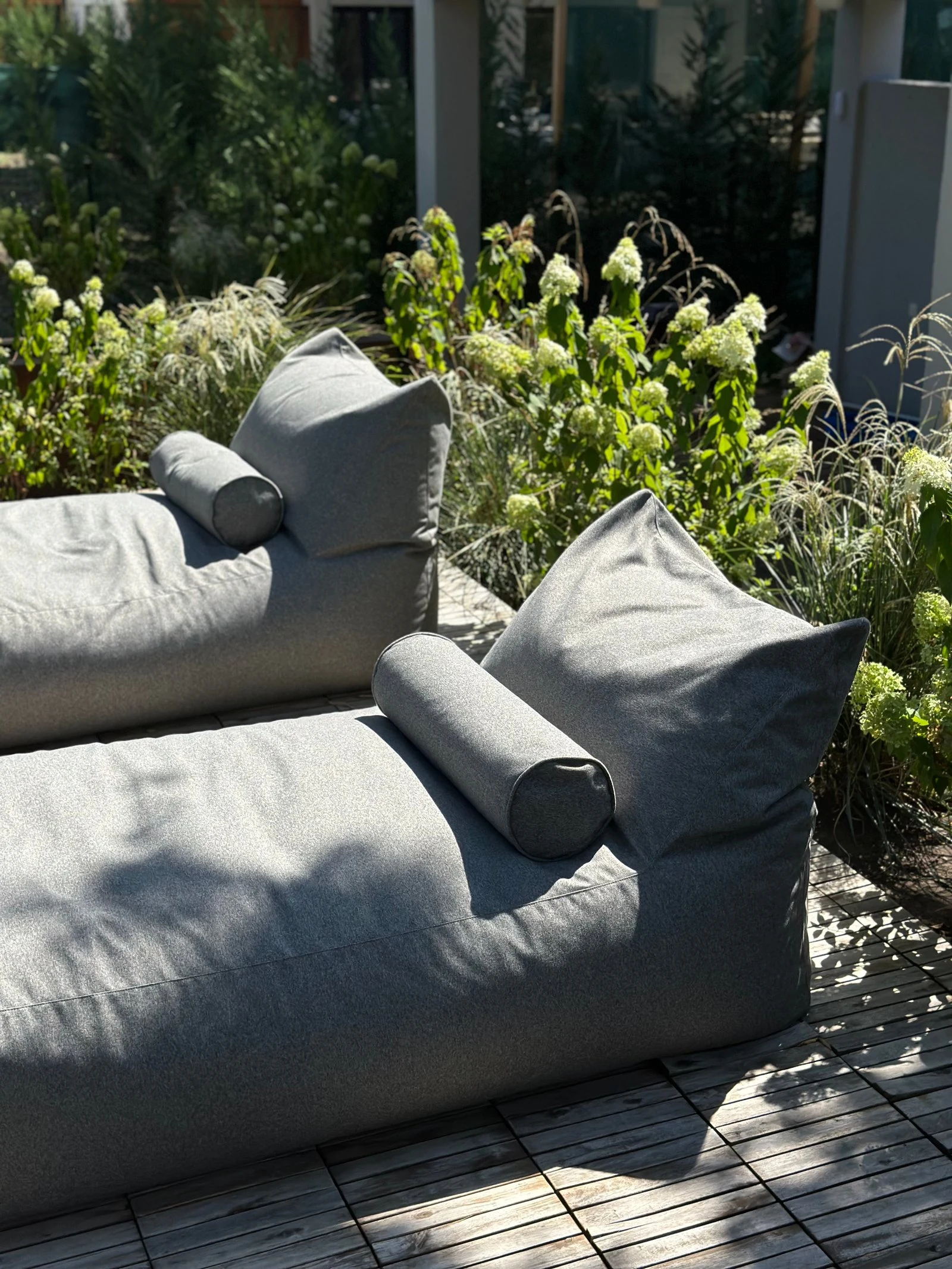 Marolla lounger by a pool with model in the background