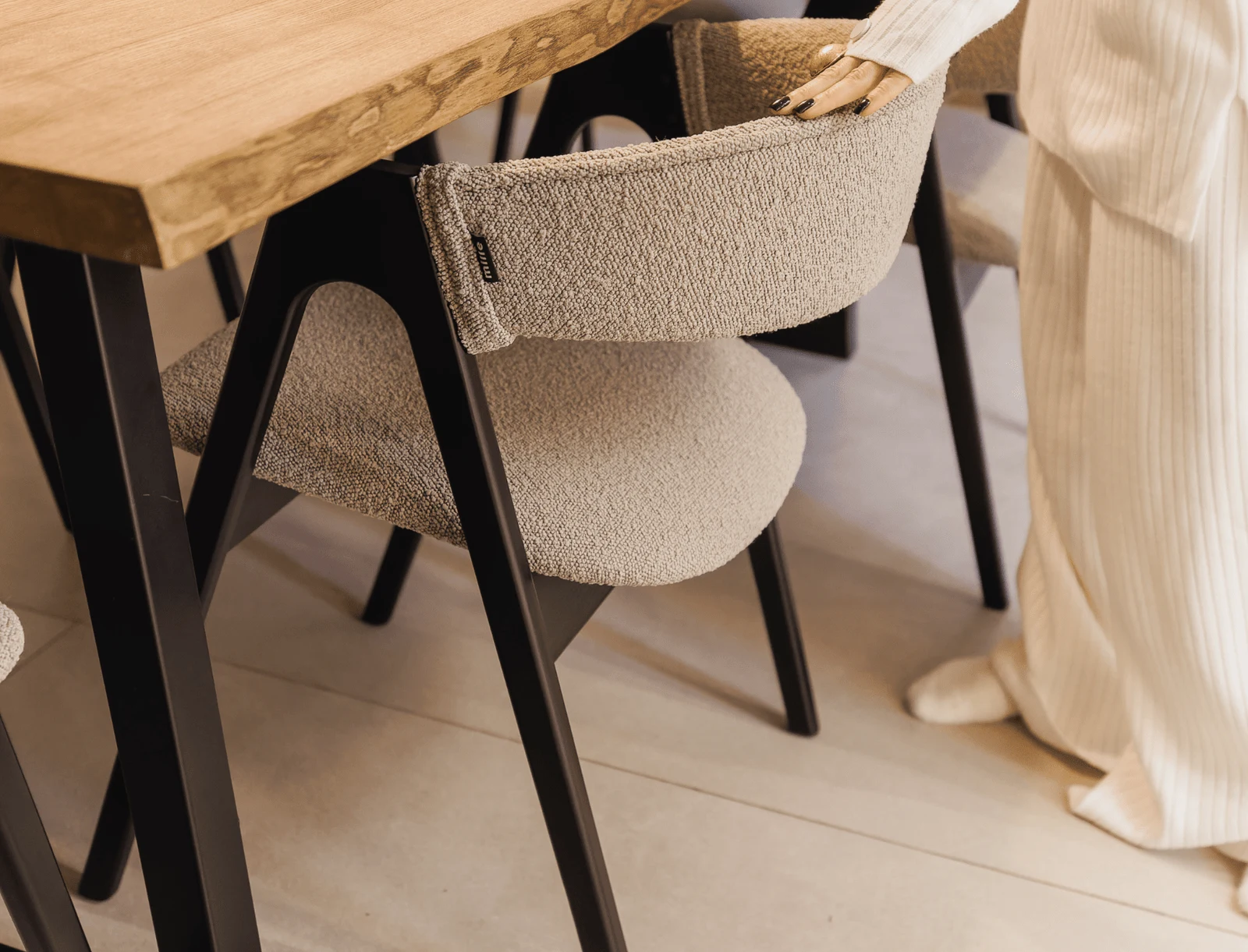 Cream Copenhaghen 803 boucle Lain chair on a black-stained ash sawhorse frame at a dining table