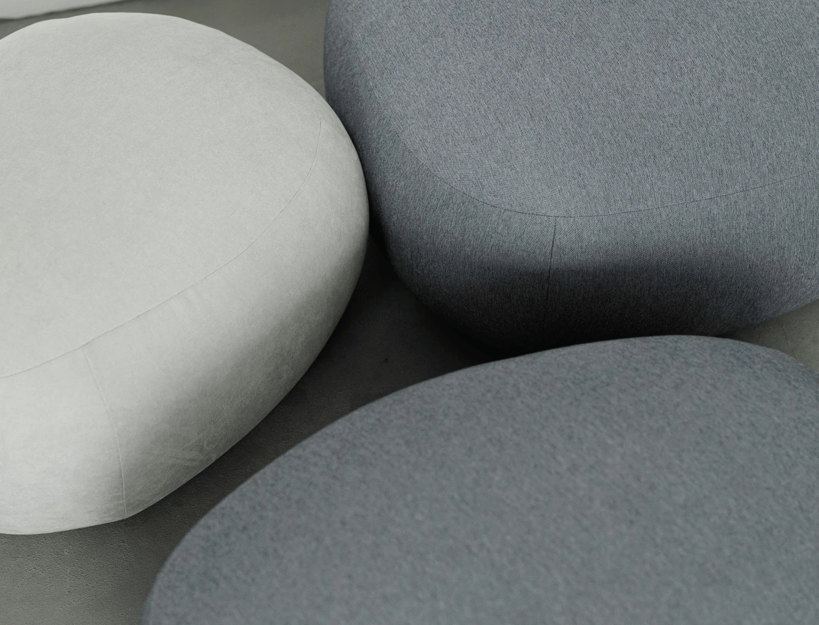 Side angle of velvet Chios pouf with marble wall