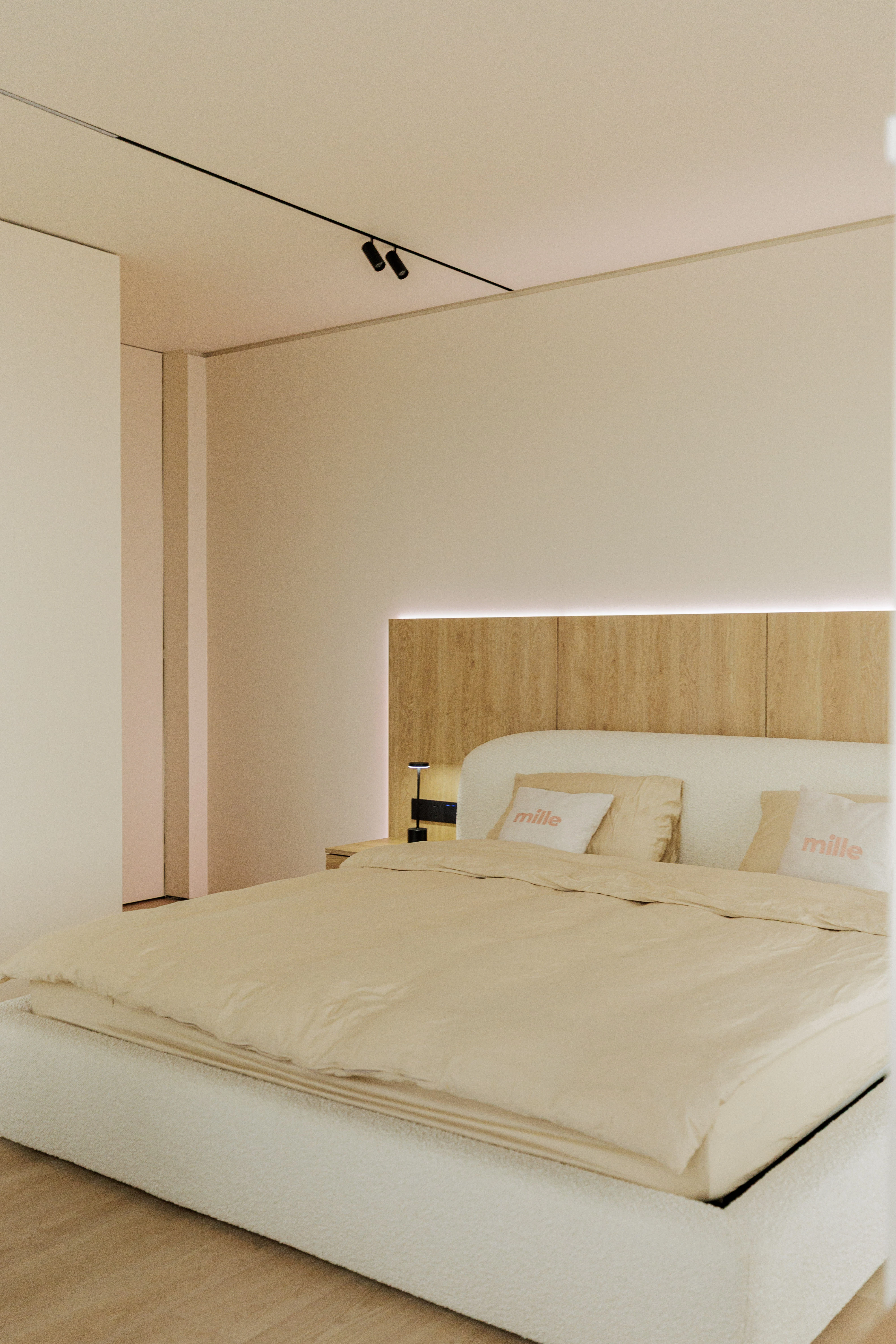 Cream boucle Belagio in a real apartment bedroom with a wood-paneled accent wall lit by a warm LED strip above and below