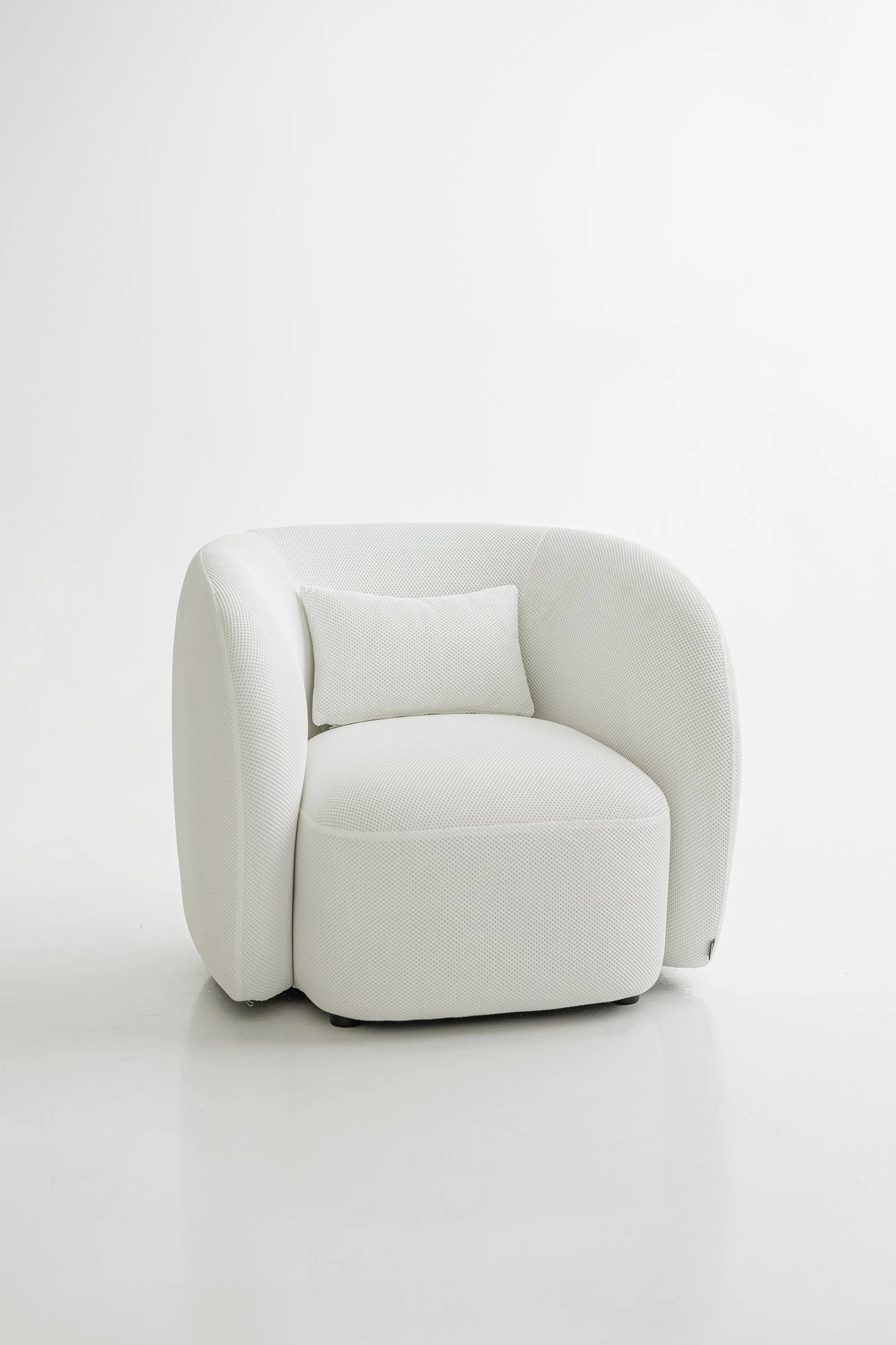 White Saturn 900 Nuba armchair in a textural honeycomb-like Belgian weave, studio photographed