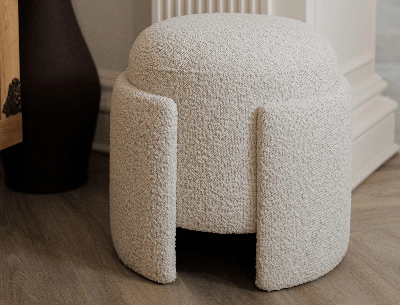 Side view of cream boucle Eden pouf showing the strap panels