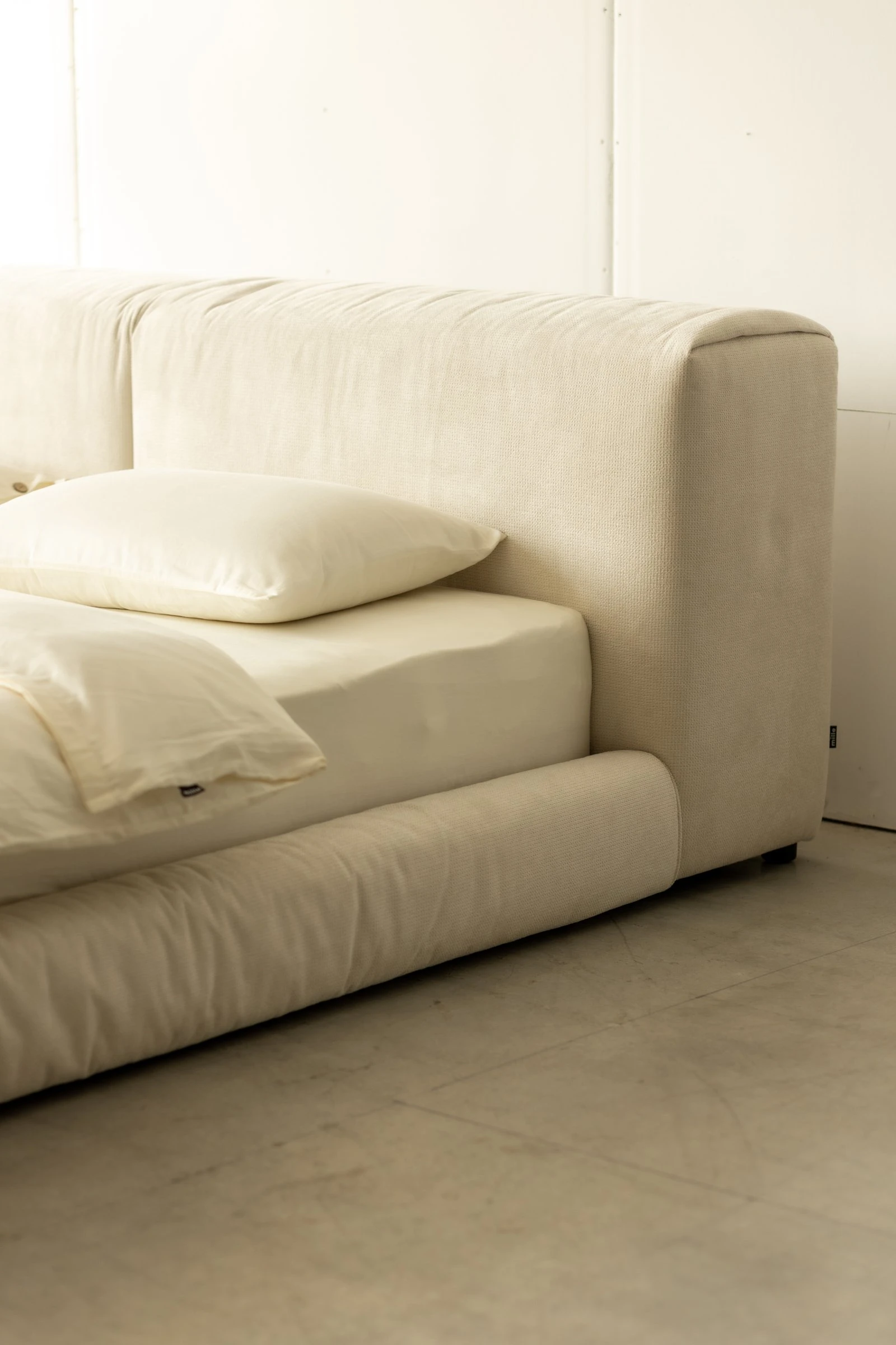 Side detail of the Marmaris showing the slouchy headboard meeting the bed and the rolled bumper at floor level