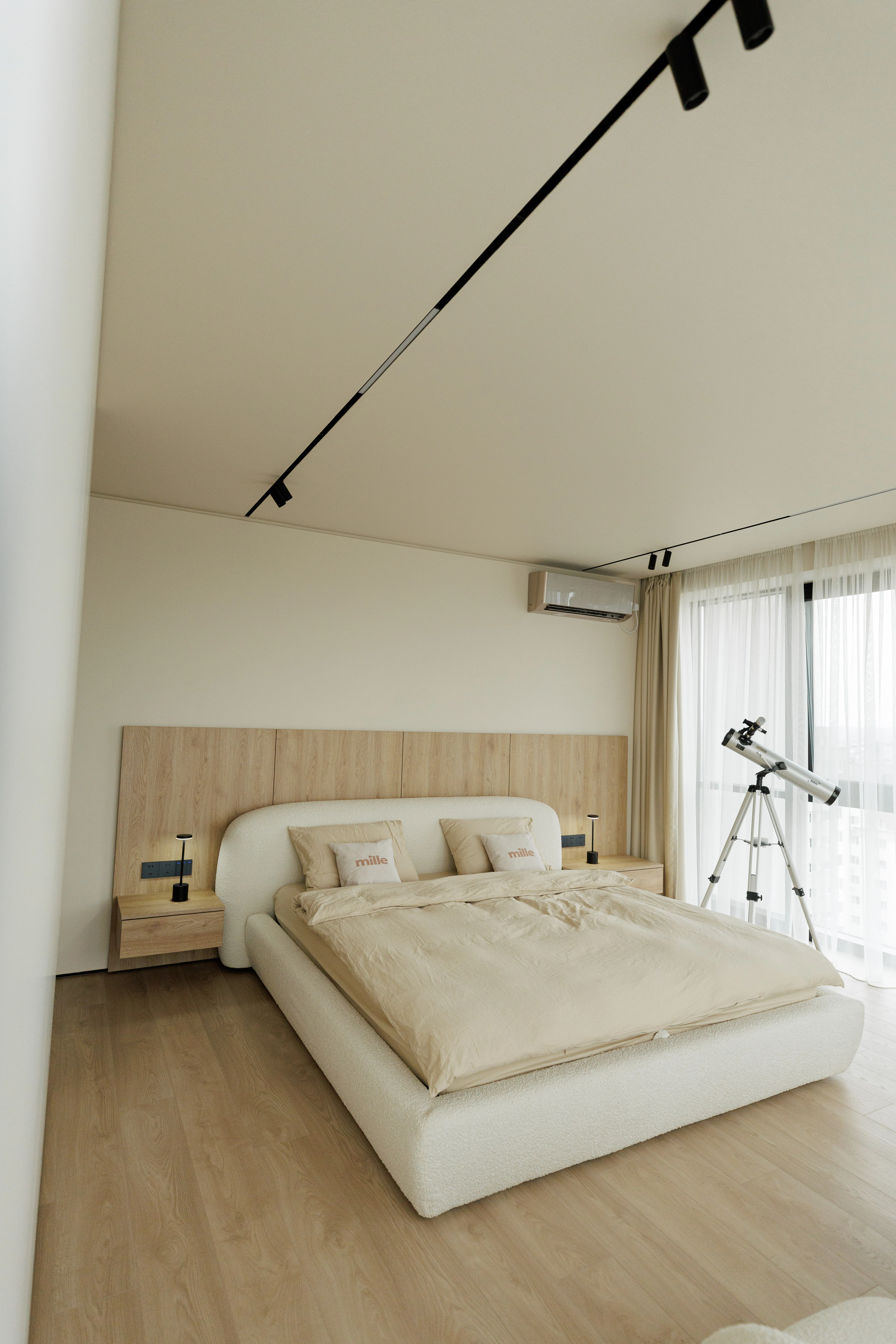 Wide view of the apartment bedroom: Belagio against the wood-paneled accent wall, a small telescope by a floor-to-ceiling window