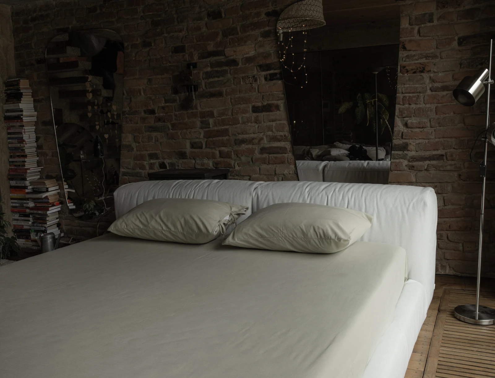 Cream Soho 900 Marmaris in a rustic brick loft with a stack of books, a vintage radio and a floor lamp