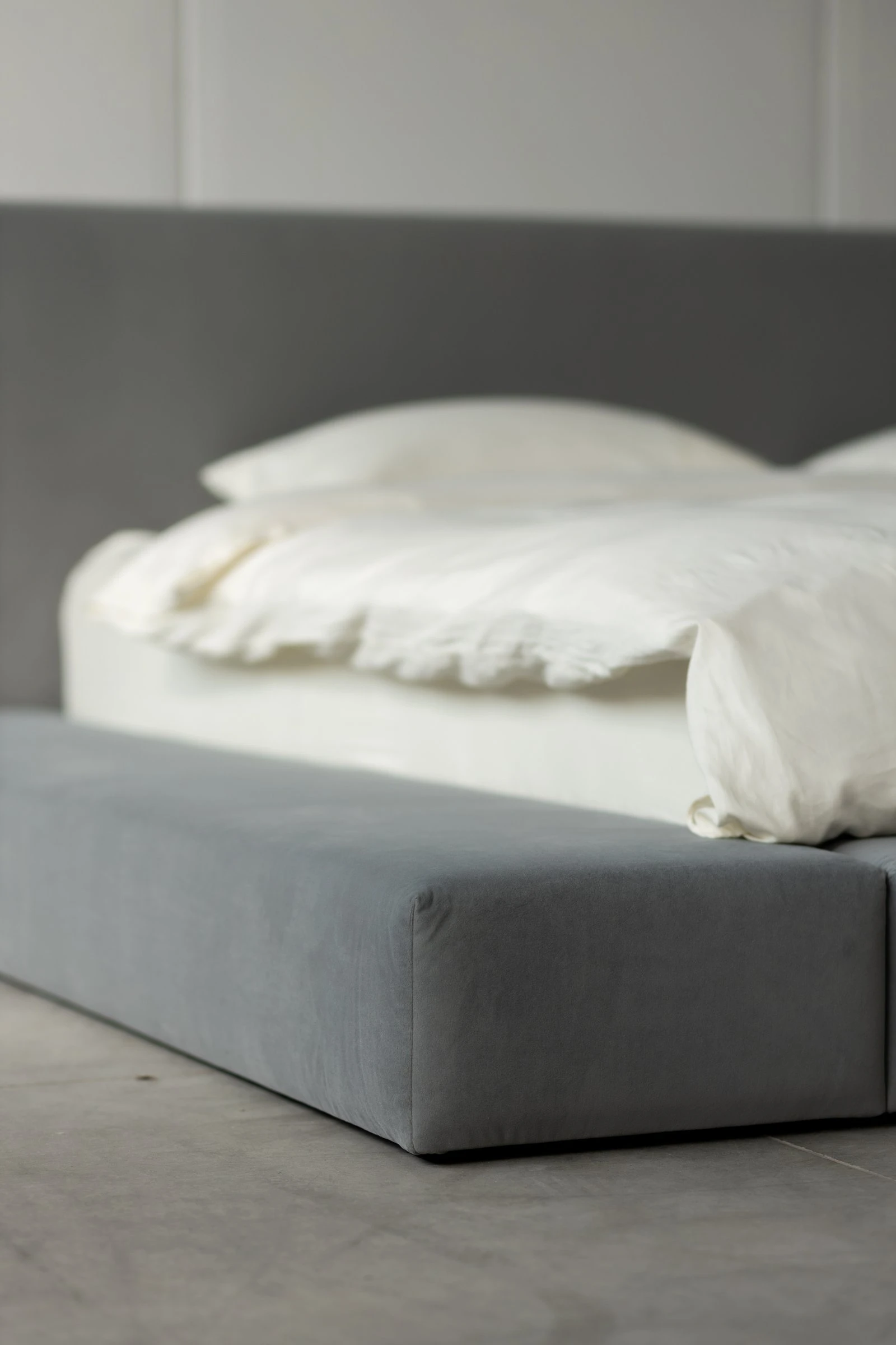 Close detail of the grey velvet Connect bumper meeting the bed body