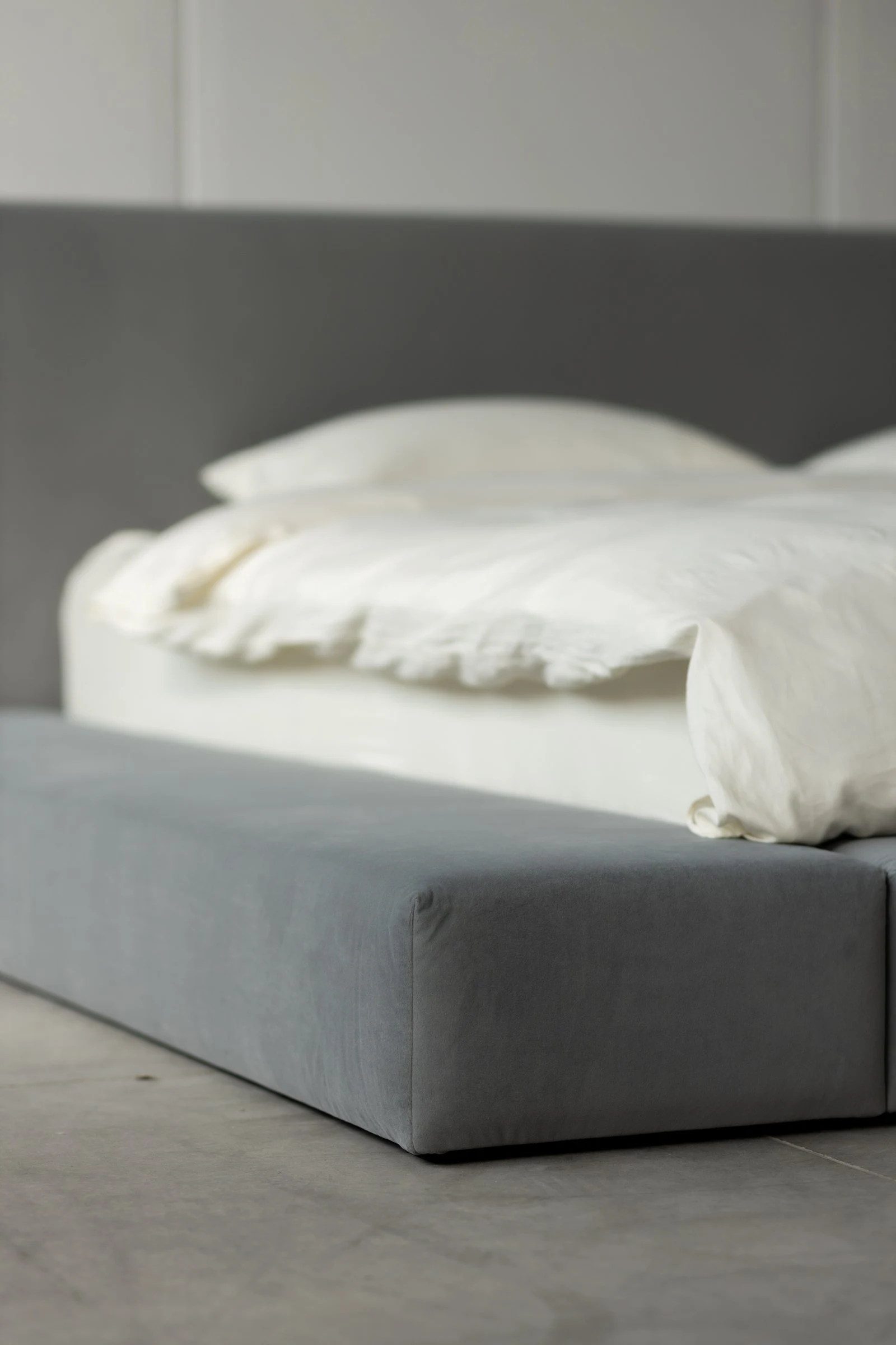 Close detail of the grey velvet Connect bumper meeting the bed body