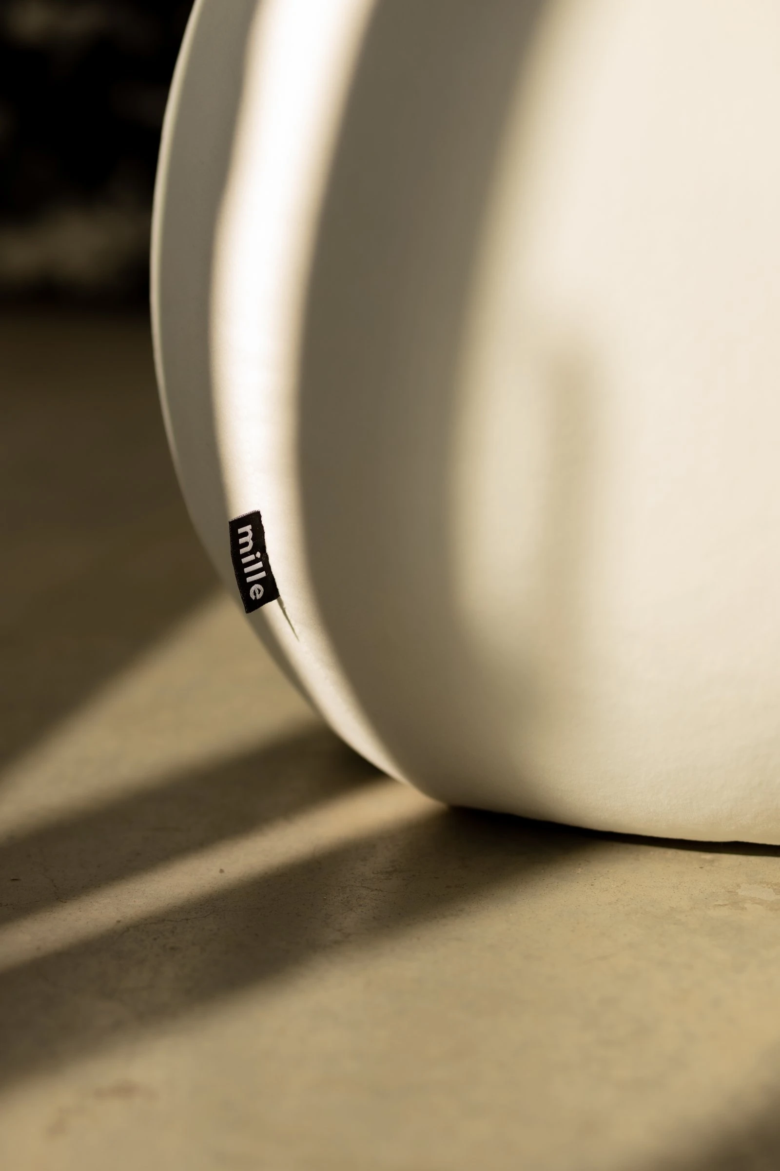 Three Chios poufs in a cement-floor studio with pampas grass