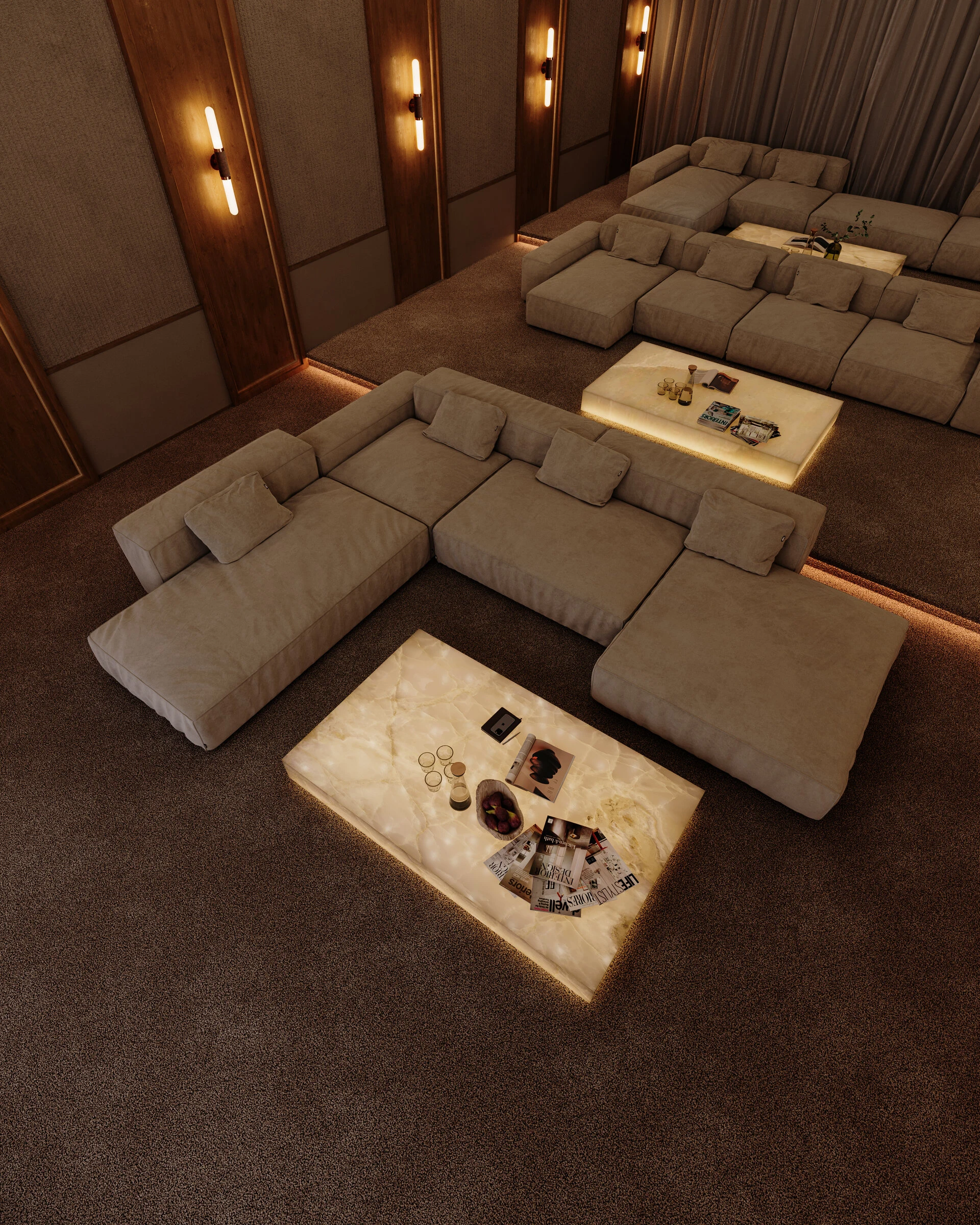 Two greige Milano L-shape sectionals around glowing onyx coffee tables in a home cinema lit by wall sconces