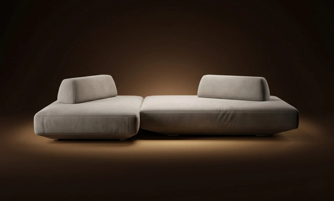 Cream Deseda two-piece sectional with separate bolsters on a warm-dark spotlit stage