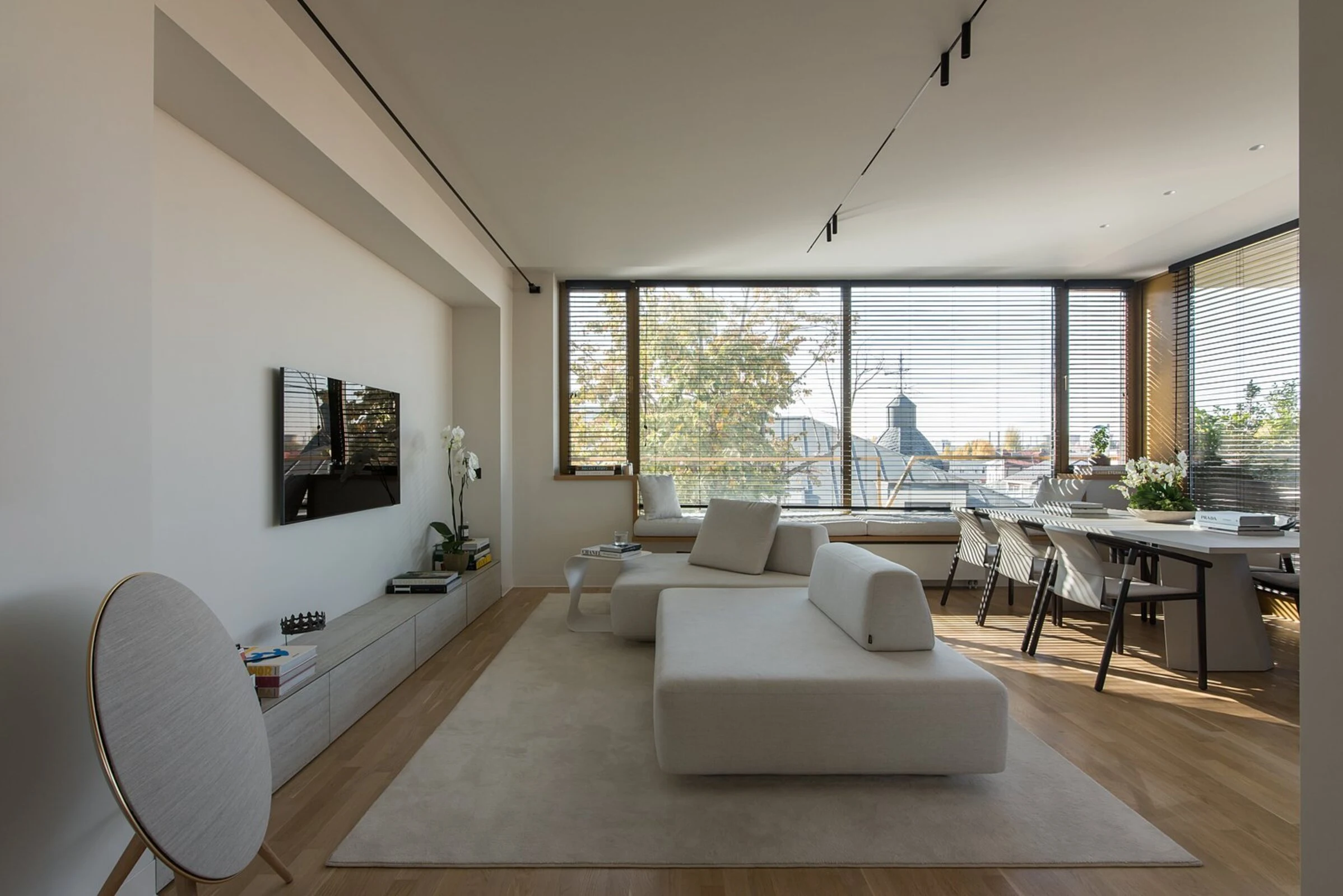 Cream Deseda in a real apartment with city views through grid-paned windows
