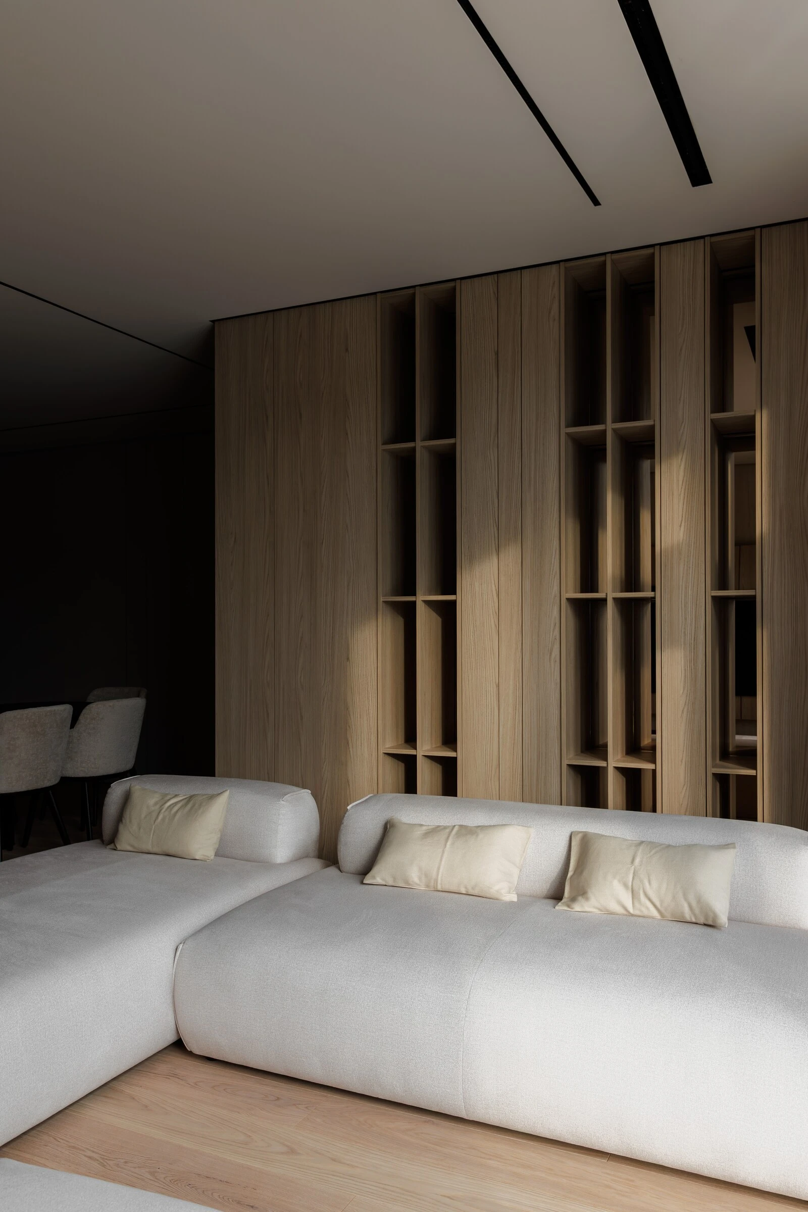 Close detail of the cream Nissa with gold-yellow pillows against an oak slat wall