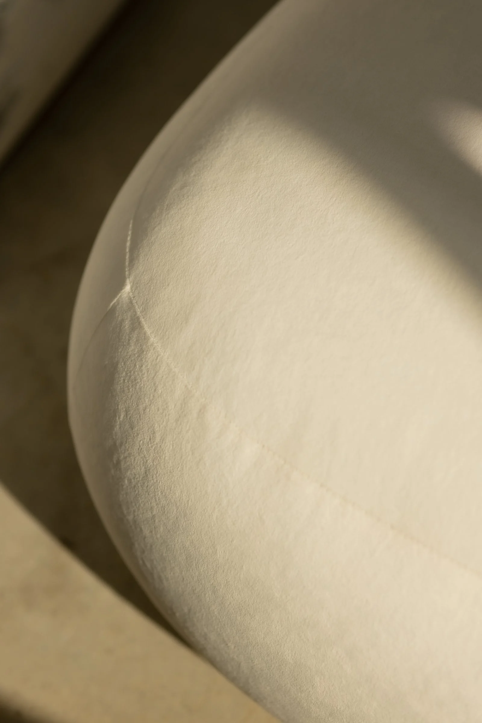 Close detail of the Chios pouf showing the single top seam running across the form