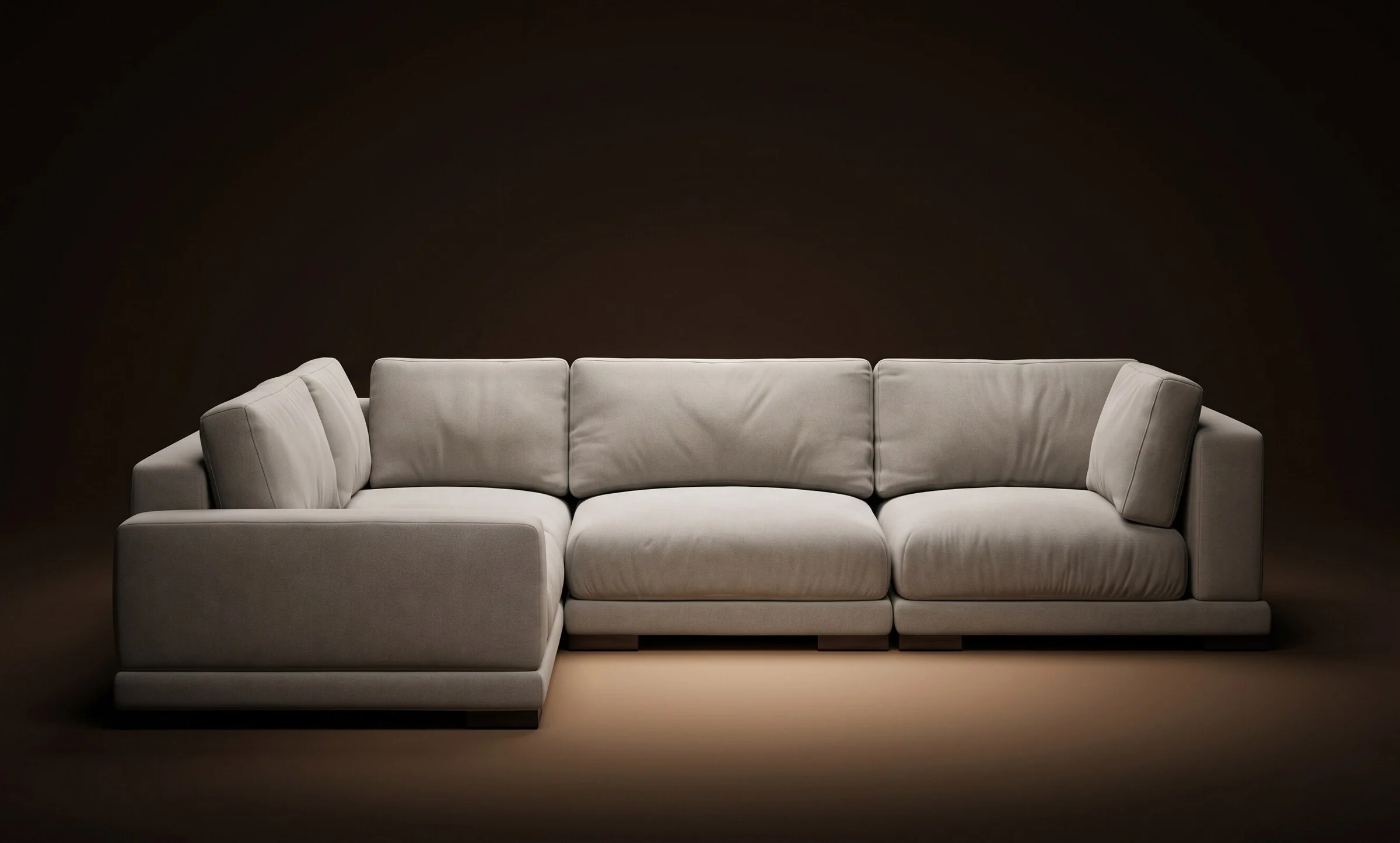 Cream Palermo L-shape sectional on a warm-dark spotlit stage