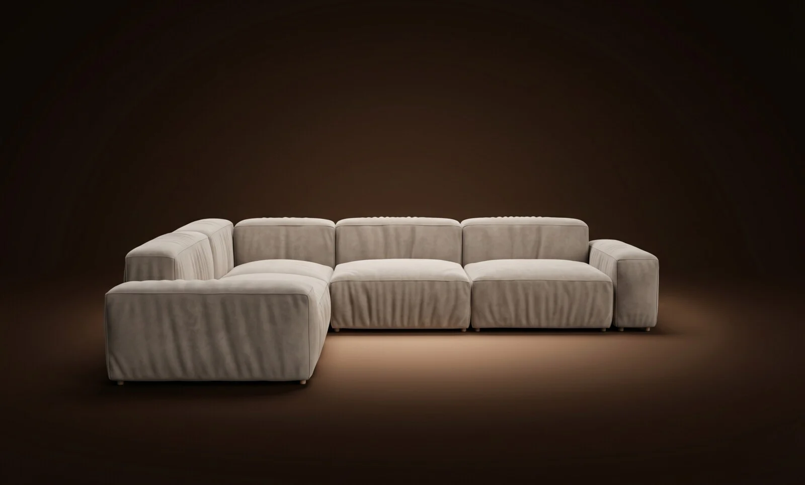 Cream Milano in a full corner L with chaise configuration on a dark spotlit stage