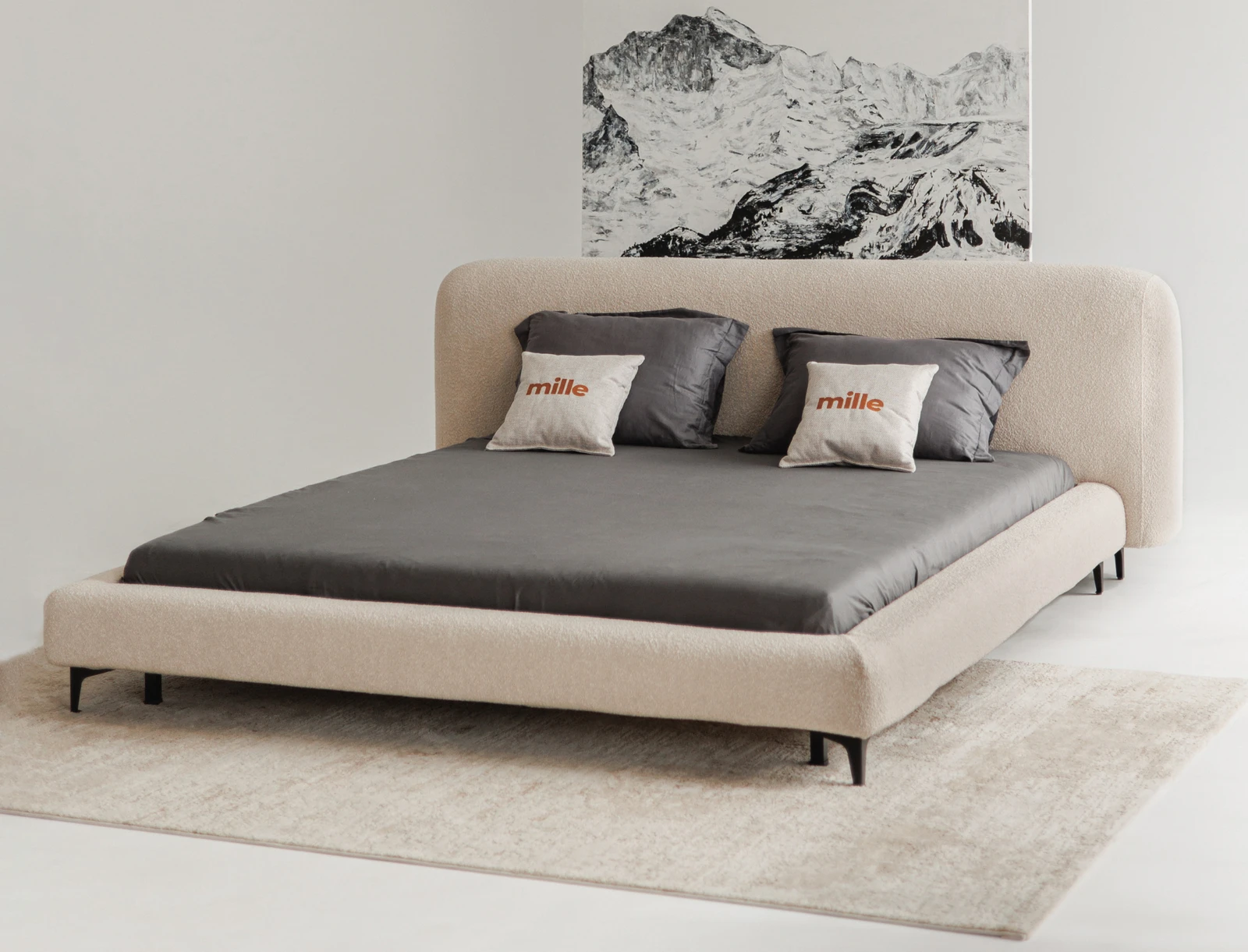 Sand Fresco bed centered against a black-and-white mountain ink drawing in a clean studio, Mille coral pillows on grey bedding