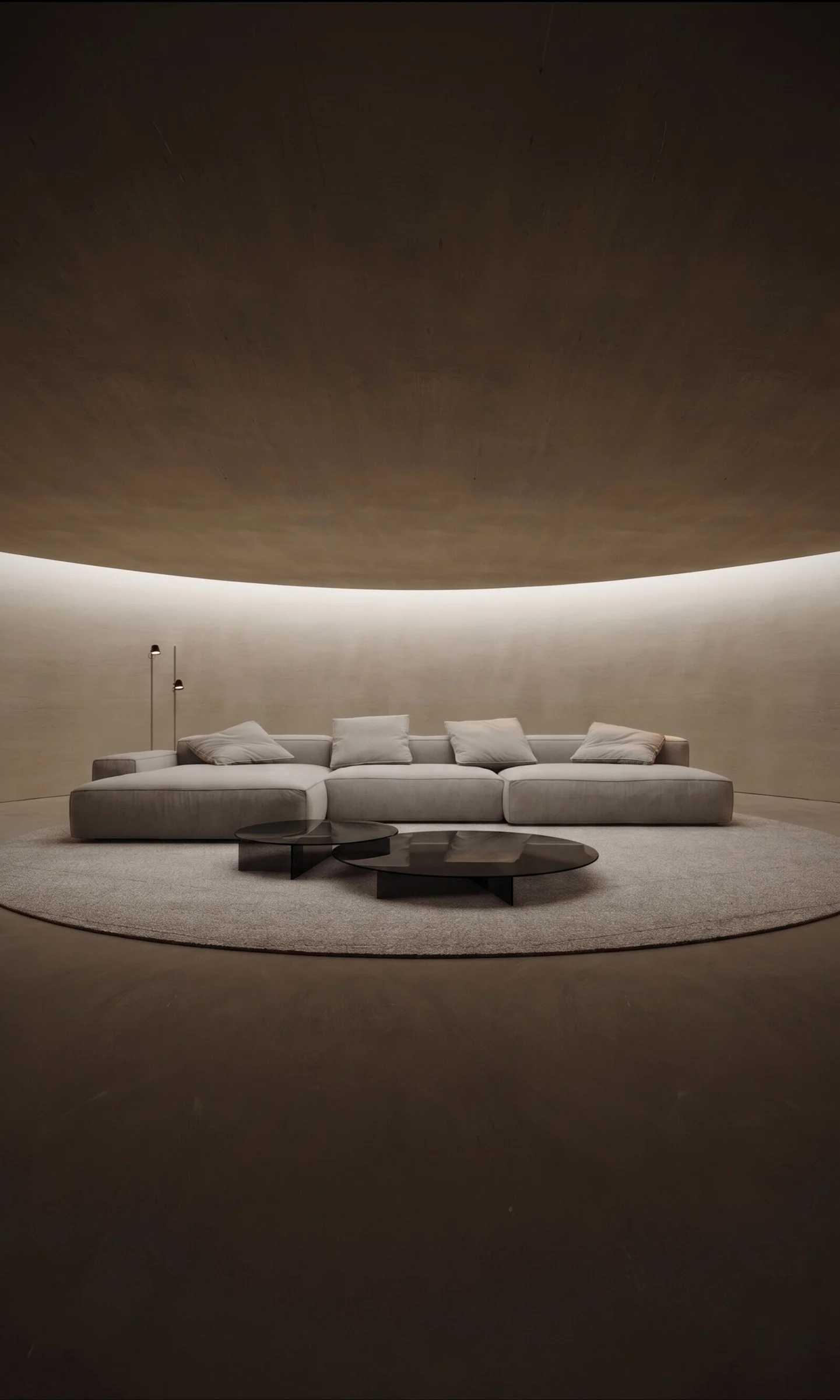 The Milano sectional sofa centered in a circular Mille interior with warm ambient cove lighting