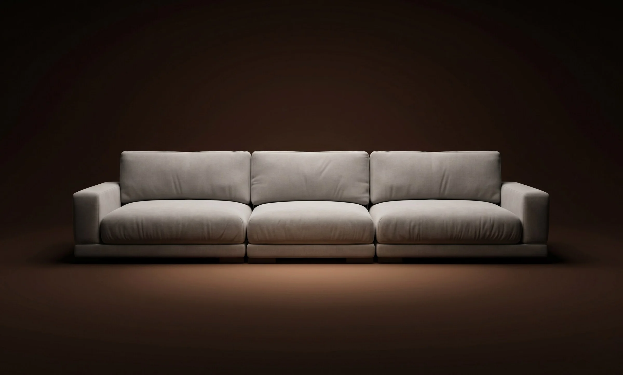 Cream Palermo three-seater straight on a warm-dark spotlit stage