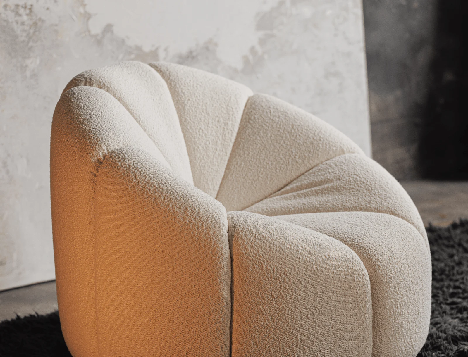 Close detail of one Flora petal showing the seam between it and the next petal in the cream boucle weave