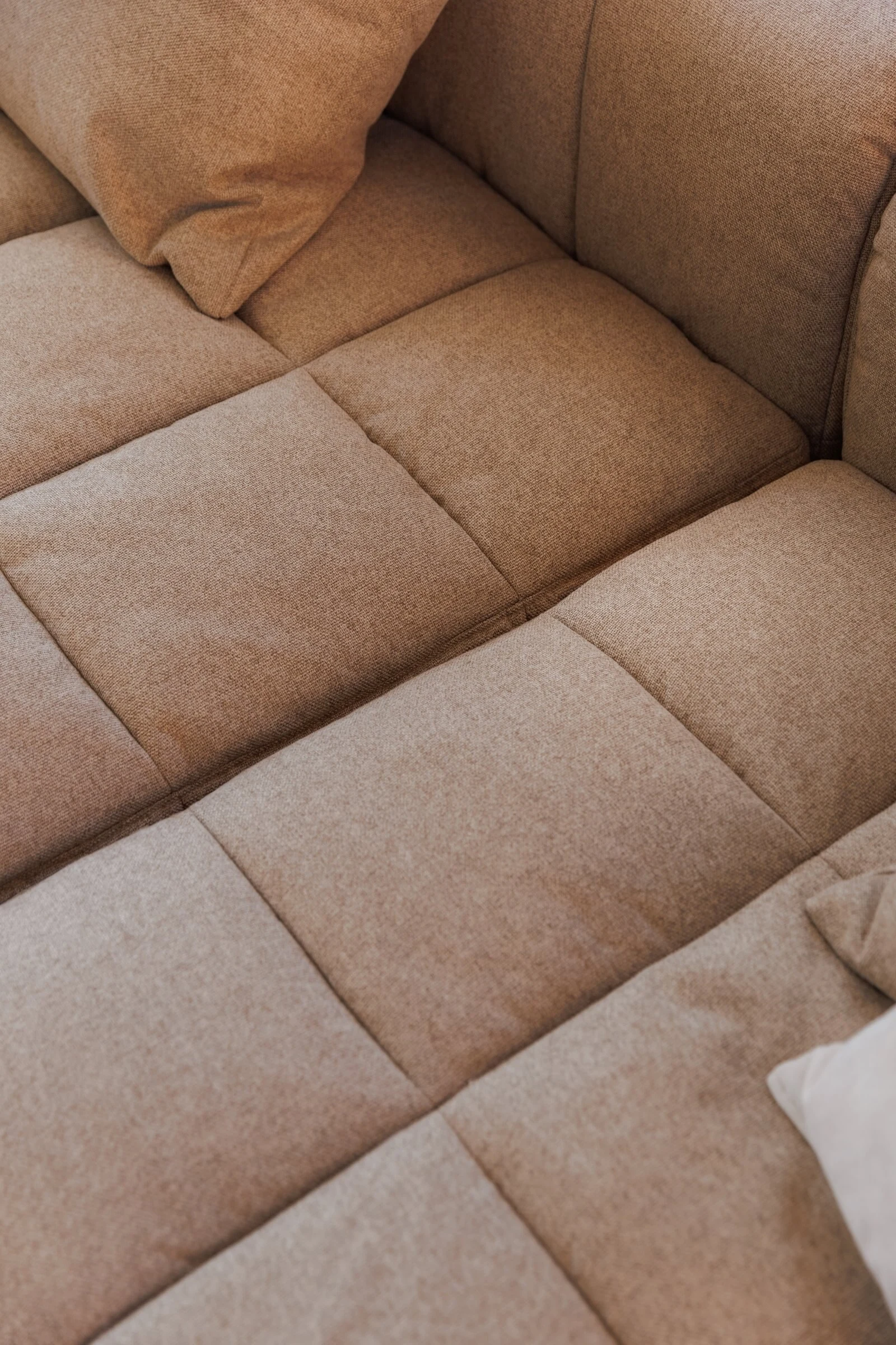 Macro detail of oat boucle weave on the Soft cushions and armrest