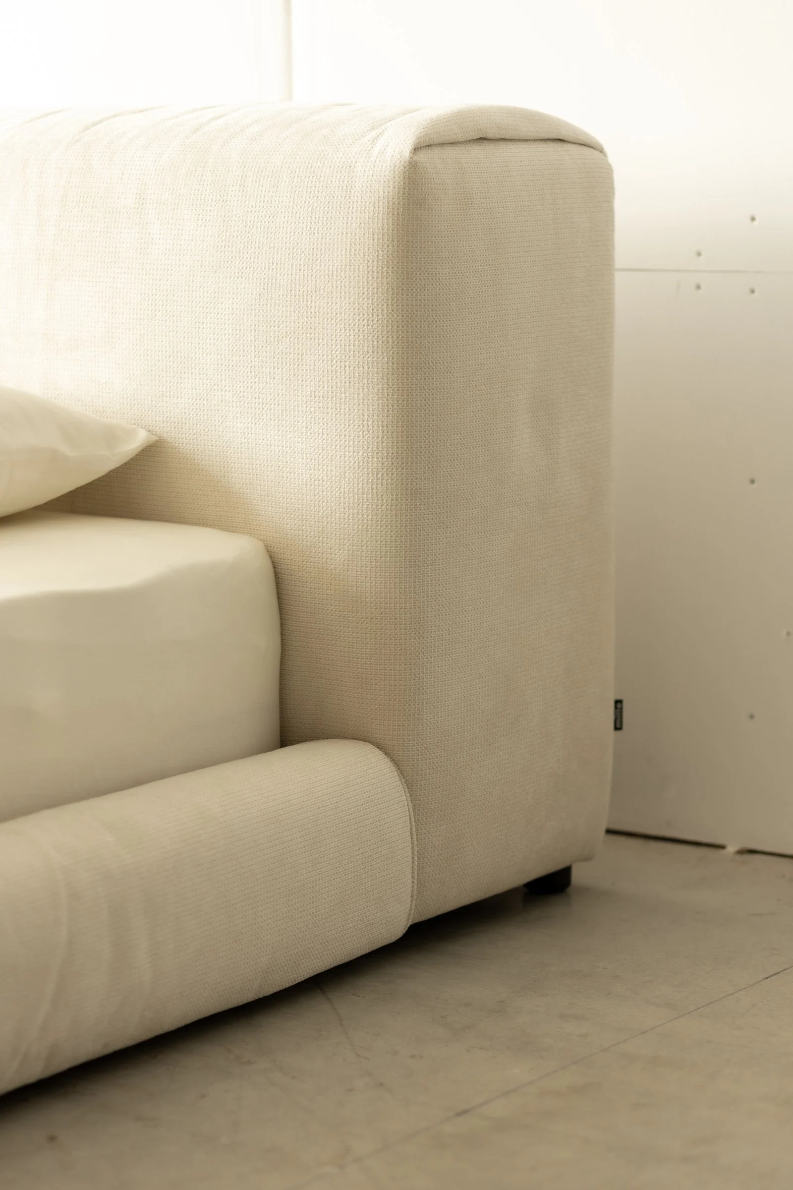 Side detail of the Marmaris showing the slouchy headboard top corner falling naturally and the rolled bumper meeting the floor