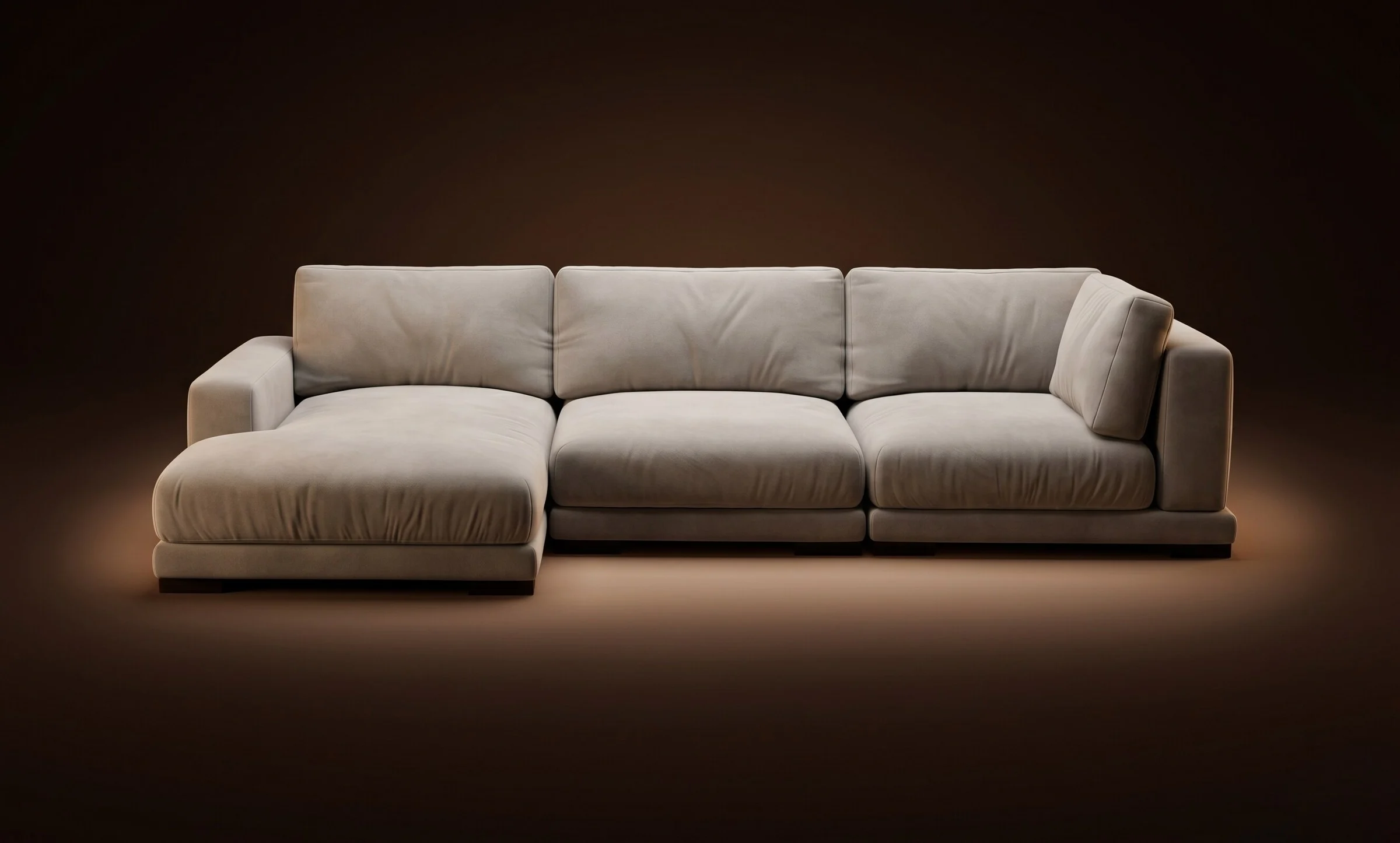 Cream Palermo three-seater with chaise on a warm-dark spotlit stage