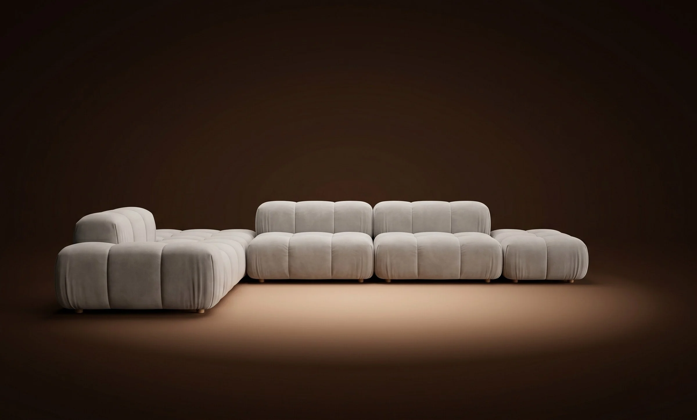 Cream Nami in a wider open configuration with ottoman on a dark spotlit stage